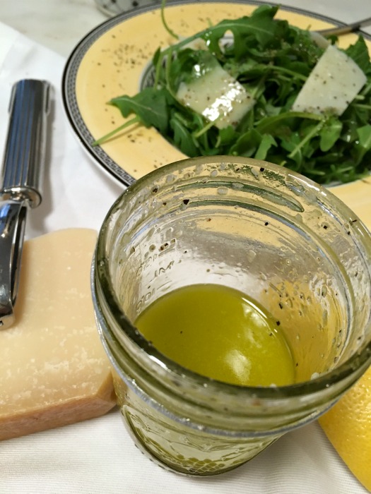 Top over arugula with fresh parmesan 