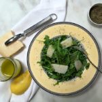 Top over arugula with fresh parmesan