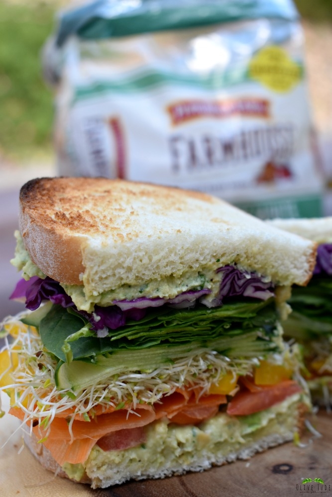 Colorful Veggie Sandwich with Chunky Chickpea Spread #BakedwithCare #FarmhouseBread #ad